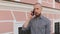Bald bearded man using smart phone surfing social media