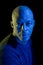 Bald black man with blue and yellow light, isolated on black background, looking at the camera.