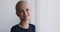 Bald cancer patient girl feels optimistic smile looking at camera