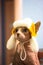 Bald cat in hat with earflap. Sphynx kitty in yellow cap Funny cute naked sphinx