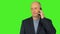 Bald caucasian man look to camera and hold smart phone at ear. Caucasian man talks by phone. Man speaking pn phone