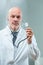 Bald doctor displays stethoscope, unsettling confidence