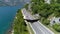 Bald Eagle Flies Over the Road Along the Sea