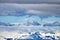 Bald eagle soaring over snow capped mountains in Juneau Alaska