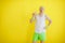 Bald funny man with a donut on a yellow background. funny fitness. retro style