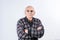 Bald grandfather in glasses and warm sweater posing arms crossed