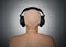 Bald head with headphones, rear view.