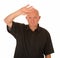 Bald headed man shielding eyes