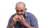A bald man greedily bites a Burger isolated on a white background