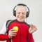 Bald man with headphones listens to music through a yellow apple player. Metaphor and concept of vitamin benefits in music and