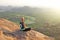 A bald man looks at the sunset at Hampi. Top Hampi. A man sits on top of a mountain and looks into the distance. Meditation, rest