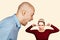 Bald man side view screaming at girl closing ears. Family abuse, scandal. on light background