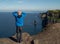 Bald man standing on the edge of Cliff of Moher