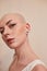 Bald masculine woman posing fashionably with serious emotions