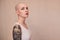 Bald masculine woman posing fashionably with serious emotions