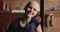 Bald woman cancer patient holding lavender smiling looking at camera