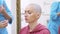 Bald woman at a consultation with a doctor in a clinic. The concept of trichology, oncology, alopecia.