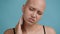 Bald Woman Suffering From Ear Pain Having Otitis, Blue Background