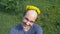 Balding man with a wreath of dandelions on his head. looking at the camera