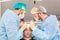Baldness treatment. Hair transplant. Surgeons in the operating room carry out hair transplant surgery. Surgical