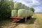 Bale of hay on the wagon in the park in the village Zuidland in summer.