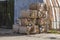 Bales of cardboard and box board with strapping wire ties. Background of paper textures piled ready to recycle.