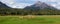 Bales of Hay in a farm field with Canadian Rocky Mountains