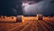 Bales of hay on the field during a lightning storm. Force of nature landscape. Agricultural field with straw bales and lightning