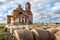 Bales of hay in the foreground in the background dilapidated Church old from the time of the Russian Empire