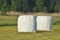 Bales of hay lying on the meadow during haymaking. River Valley, meadows