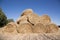 Bales of pressed straw are stacked on top of each other on the field