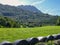 Bales of silage, plastic wrapped, in a line across a field , cantabrian landscape with mountains, Spain