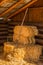 Bales of Straw Hay with Pitchfork in Barn