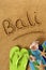 Bali beach sand word writing vertical