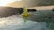 Bali, Indonesia - August, 5, 2022: Cute bright yellow inflatable duck floating on water surface carrying bintang beer