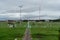 BALI/INDONESIA-DECEMBER 21 2019: some airport cleaners cut grass around the runway using a lawn mower and several tractors when