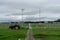 BALI/INDONESIA-DECEMBER 21 2019: some airport cleaners cut grass around the runway using a lawn mower and several tractors when