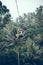 BALI, INDONESIA - DECEMBER 26, 2017: Man having fun on the swing with action camera in the jungle of Bali island