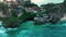 Bali, Indonesia, July 15, 2023 People tourists, surfers rest in a cafe on stone cliffs in Bali, ocean waves and ocean