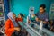 BALI, INDONESIA - MARCH 08, 2017: Unidentified man using syringes and pipettes mixing essences to prepare perfumes