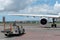 BALI/INDONESIA-MARCH 27 2019: Engine and main landing gear when aircraft park on apron in the airport with some vehicle near it.