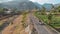 Bali, Indonesia - March 30, 2018: Alex Drone view of tourists driving scooter on small road in africa. Beautiful