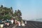 BALI, INDONESIA - MAY 19, 2018: Balinese Hindu devotees with offerings for the spirits of the sea walking to the beach