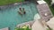 BALI, INDONESIA - NOVEMBER 8, 2017: Girlfriends in the pool. Party in the summer holidays. Girls clink glasses with