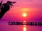 Bali sunrise over a jetty golden sunlight on the ocean