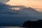 Bali at sunset with orange sky. Java volcano in the background