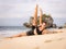 Bali yoga. Attractive woman practicing Anantasana, Sleeping Vishnu Pose. Yoga balance on side. Stretching exercise. Preparation