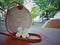 Balinese bag and Jepun flower on a wooden table