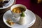 Balinese chicken gravy dish served with traditional cone shaped leave wrapped rice and vegetables