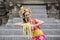 Balinese dancer dancing while carrying flower